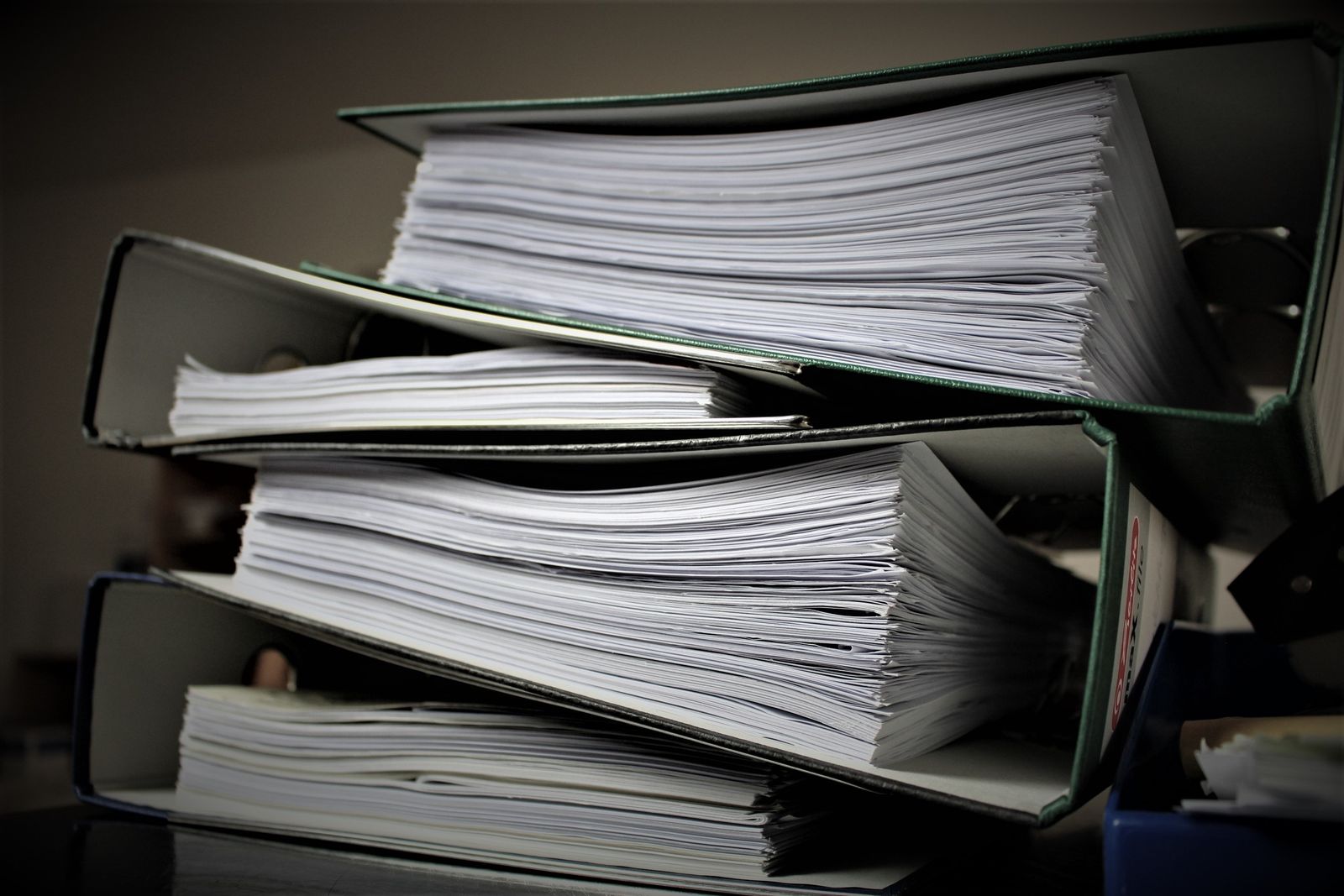 A pile of folders filled with documents