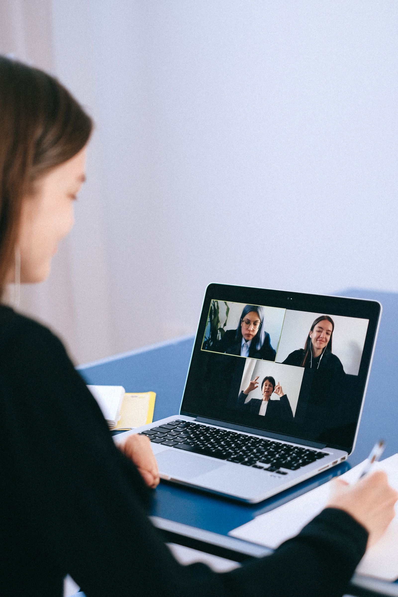 A laptop screen showing a live video class with several participants