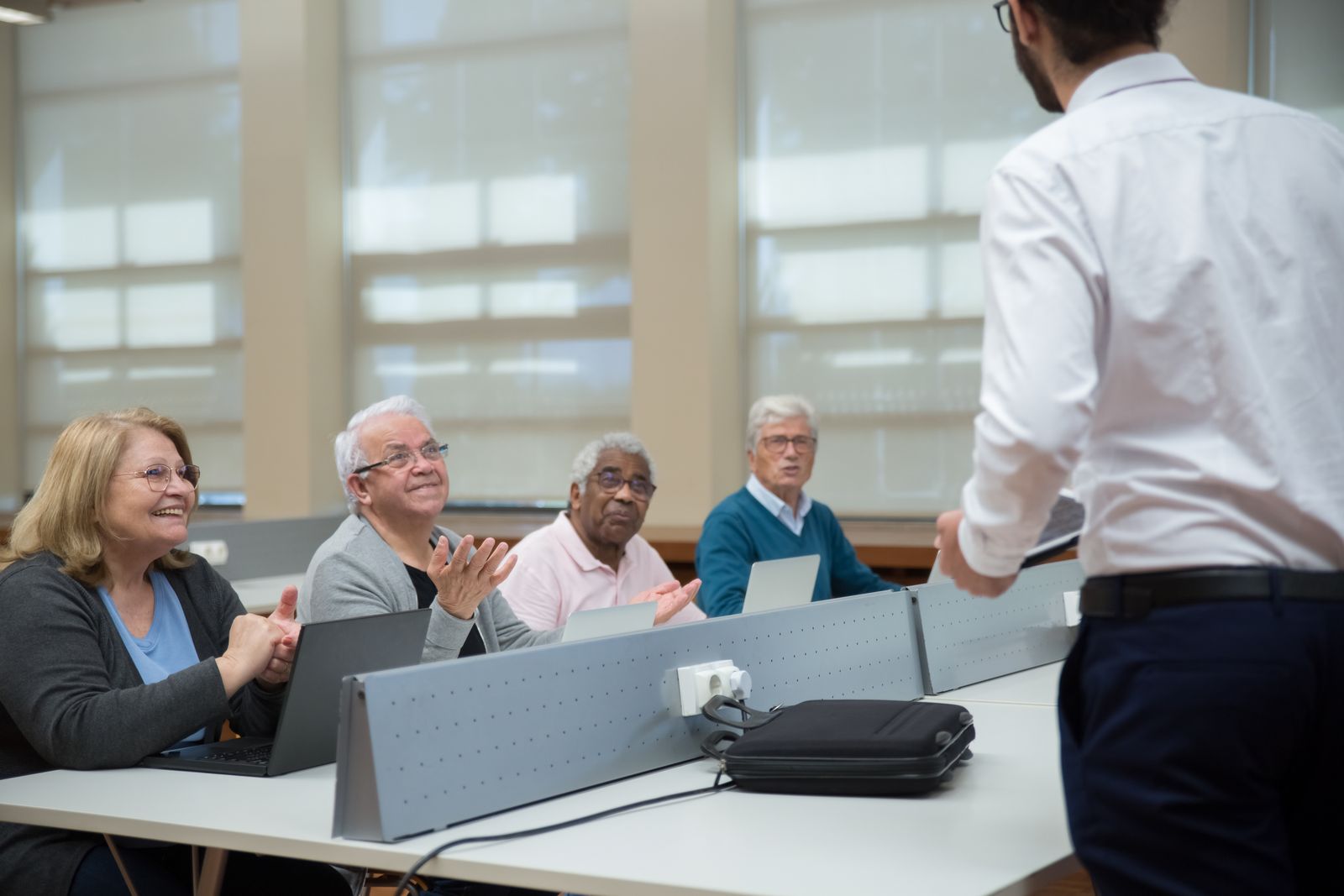 Adults seated around a table in a professional training session